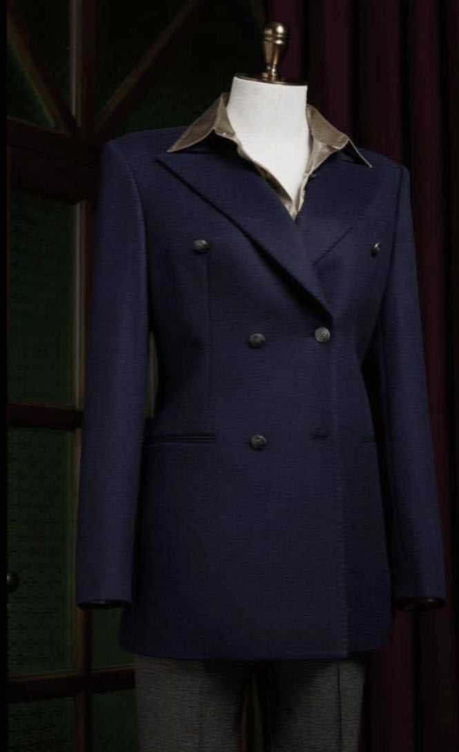 Ladies Navy blue double-breasted coat on a mannequin against a dark background