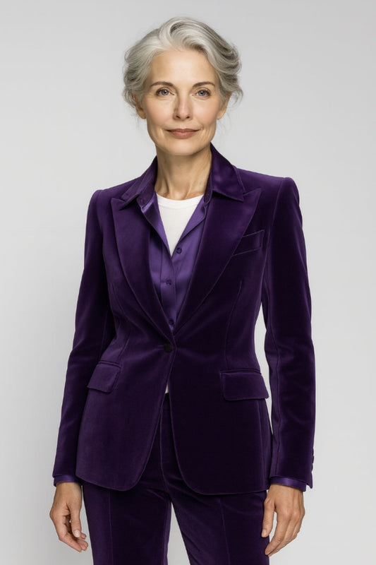 Lady wearing a purple velvet suit against a white background