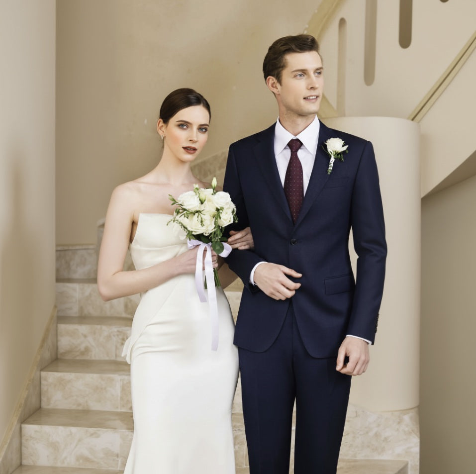 Man and woman in formal attire standing on a staircase