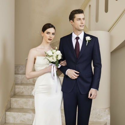Man and woman in formal attire standing on a staircase
