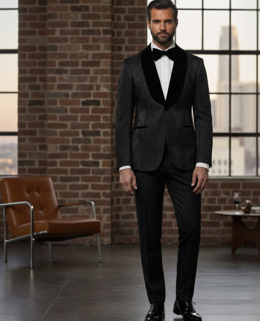 Man_in_a_black_tuxedo_standing_in_a_room_with_brick_walls_and_large_windows