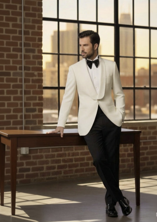Man_in_a_white_tuxedo_standing_in_a_room_with_large_windows_and_brick_walls