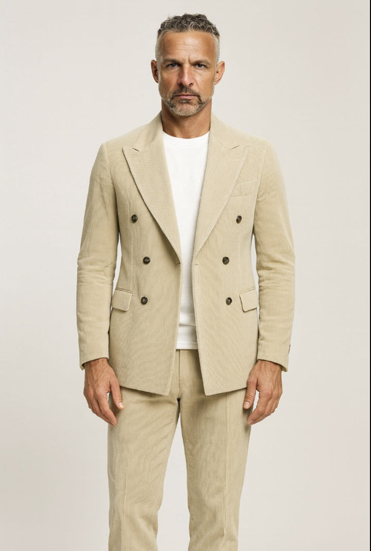 Man wearing a beige suit with a white shirt on a plain background