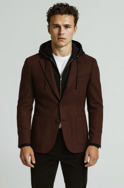 Man wearing a brown blazer with a black hood on a light gray background