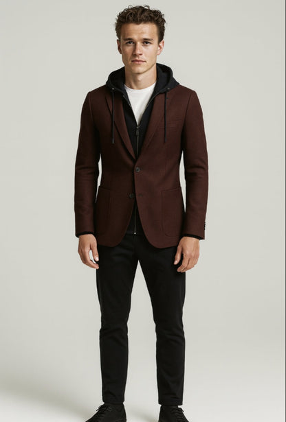 Man wearing a brown blazer with a hood over a black hoodie on a white background