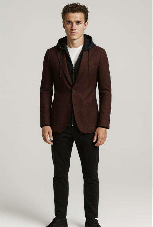 Man wearing a brown blazer with a hood over a black hoodie on a white background
