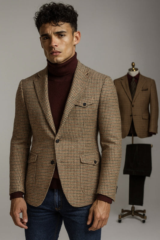 Man wearing a brown checkered blazer over a maroon turtleneck with a matching suit on a mannequin in the background.