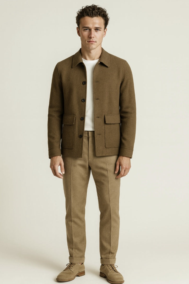 Man wearing a brown jacket and beige pants on a white background