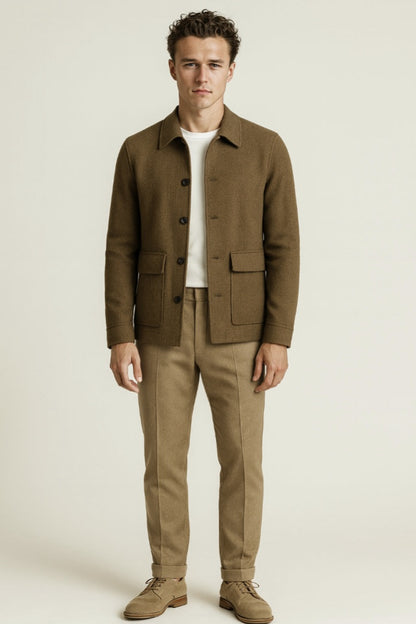 Man wearing a brown jacket and beige pants on a white background