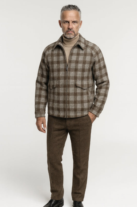 Man wearing a brown plaid shirt and pants on a white background