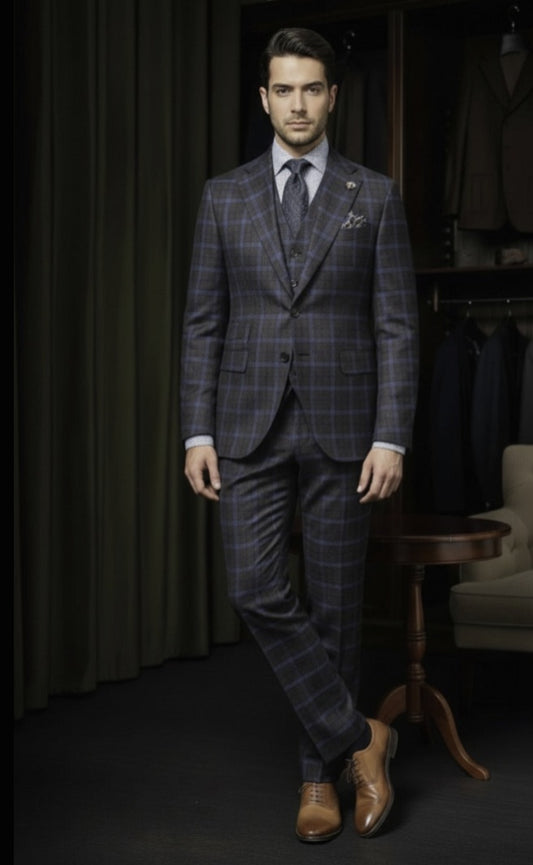 Man wearing a checkered suit standing in a room with dark curtains and a wooden table.