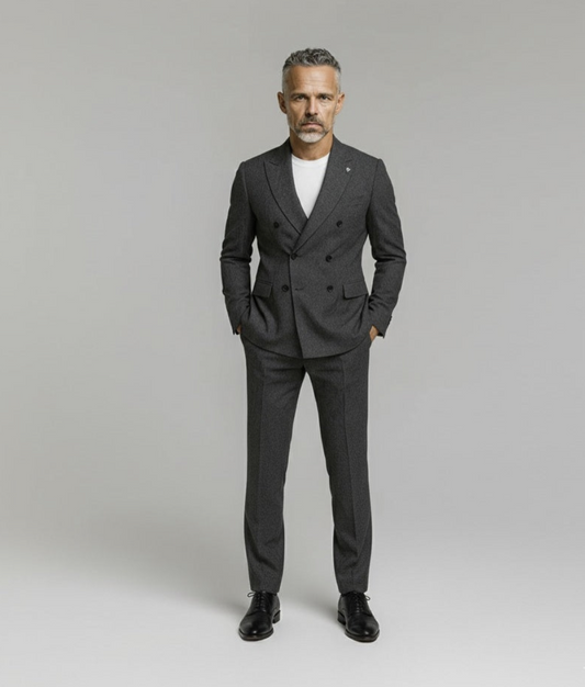 Man wearing a gray suit with a white shirt on a plain background