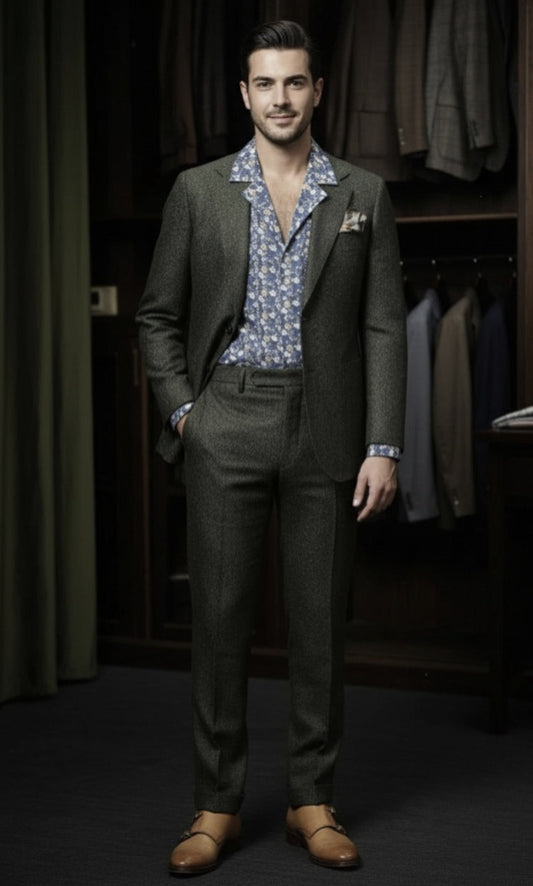 Man wearing a green suit with a patterned shirt in a clothing store.