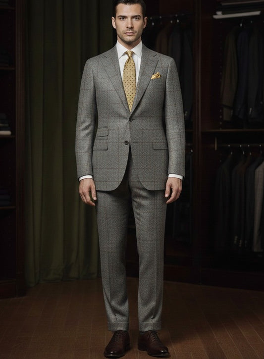 Man wearing a grey suit with a patterned tie in a clothing store.