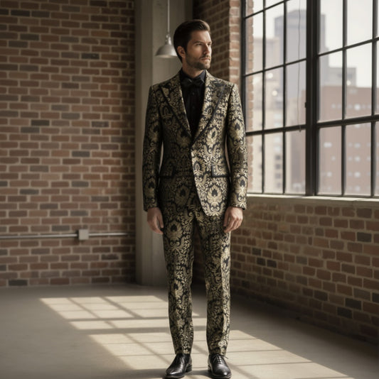 Man wearing a patterned suit standing in a room with brick walls and large windows