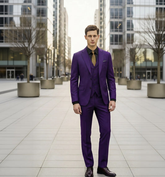 Man wearing a purple suit standing in an urban setting with modern buildings.