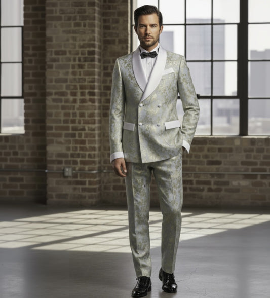 Man wearing a sage and gold patterned suit with a bow tie in an industrial-style room