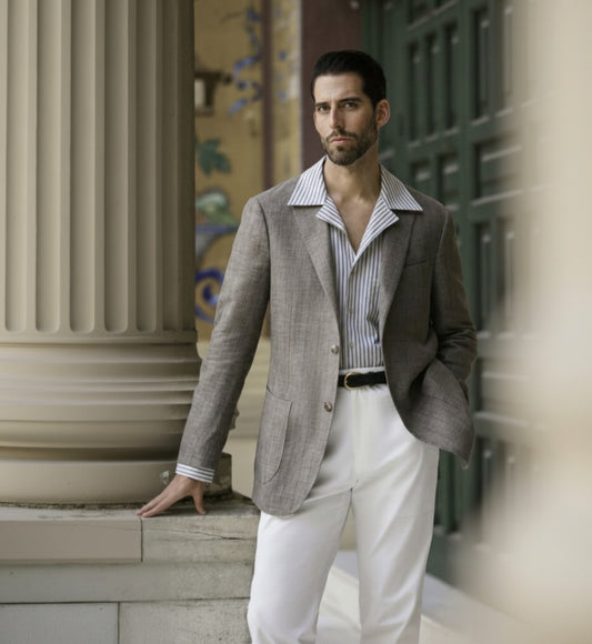 Man_wearing_a_thorn-blazer_striped_shirt_and_white_pants_standing_outdoors