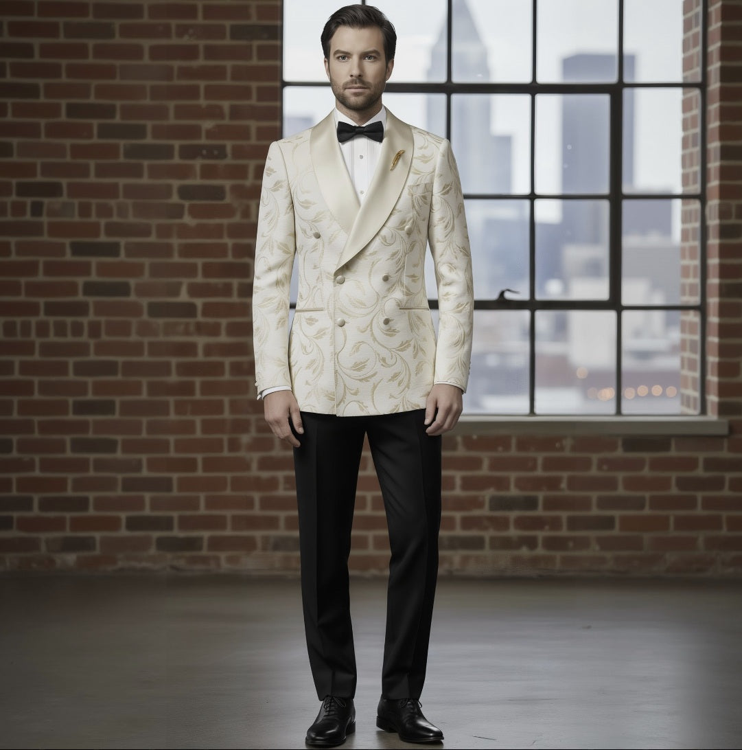 Man wearing a white floral tuxedo with black bow tie and pants, standing in front of a brick wall and window with cityscape view.