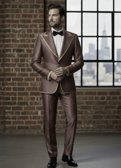 Man wearing a red and cerise  with gold trim against a brick wall and window background