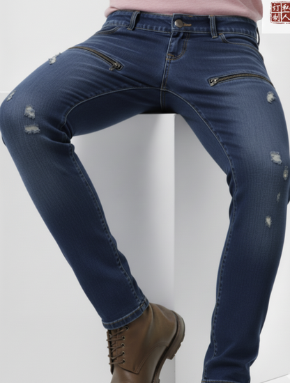 Blue jeans with distressed details worn by a person on a white background