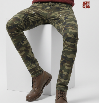 Camouflage pants worn by a person on a white background