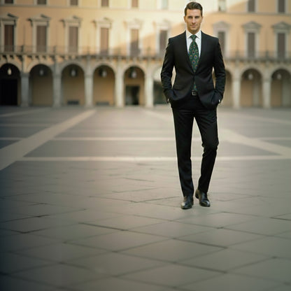 Man in a black suit walking in an open square with classical architecture.