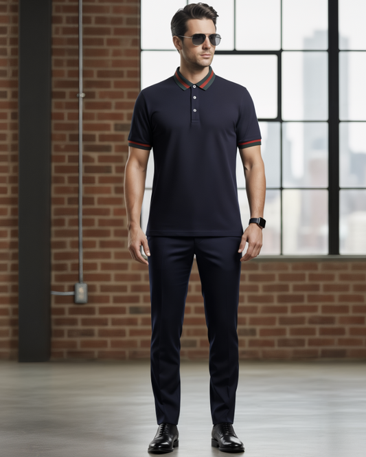 Man wearing a navy polo shirt and pants with sunglasses indoors.