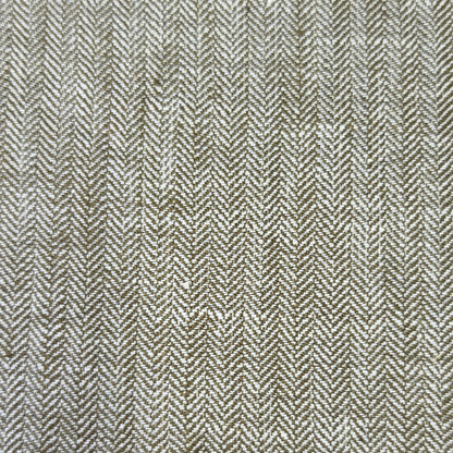 A close-up of a woven fabric with a herringbone pattern in beige and brown tones.