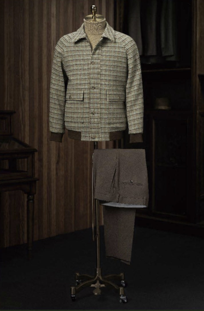 Plaid jacket on a mannequin against a dark background