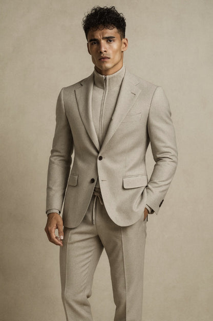 Professional man in beige contemporary bespoke suit with high-neck knit top - modern tailoring by A Hand Tailored Suit