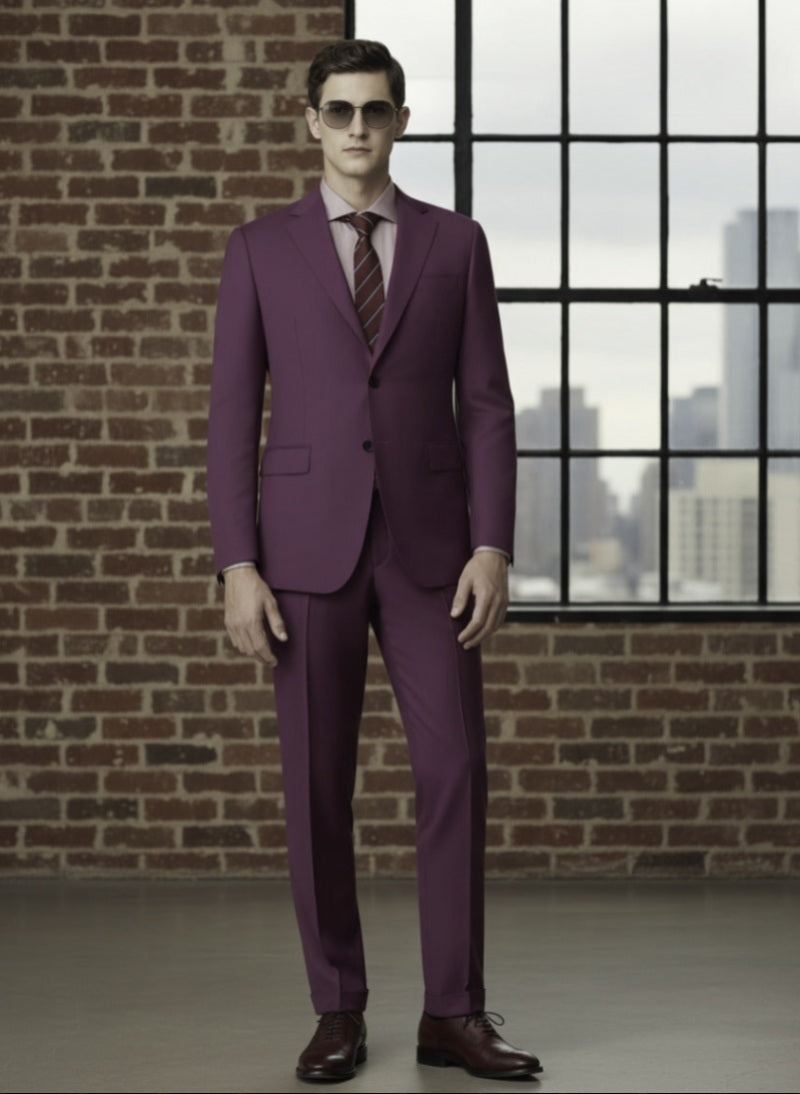 Man wearing a Red suit with sunglasses in front of a brick wall and window.