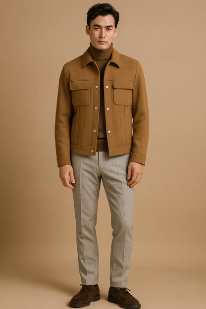 Man wearing a brown jacket and light grey pants against a beige background

