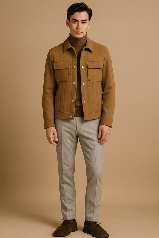 Man wearing a brown jacket and light grey pants against a beige background

