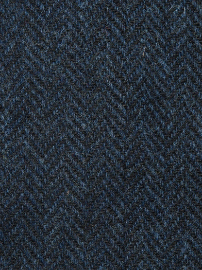 Textured fabric with a herringbone pattern in dark blue tones.