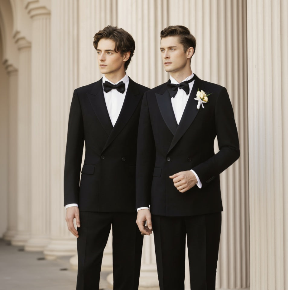 Two men in formal black suits standing against a classical architecture background