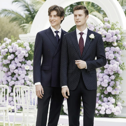 Two men in suits standing in front of a floral archway.