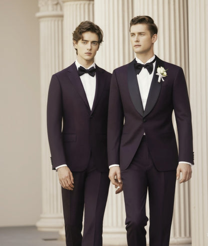 Two men wearing purple jacquard evening suits with matching trousers, one with a jacket and waistcoat and the other with a bow tie and a flower pin.