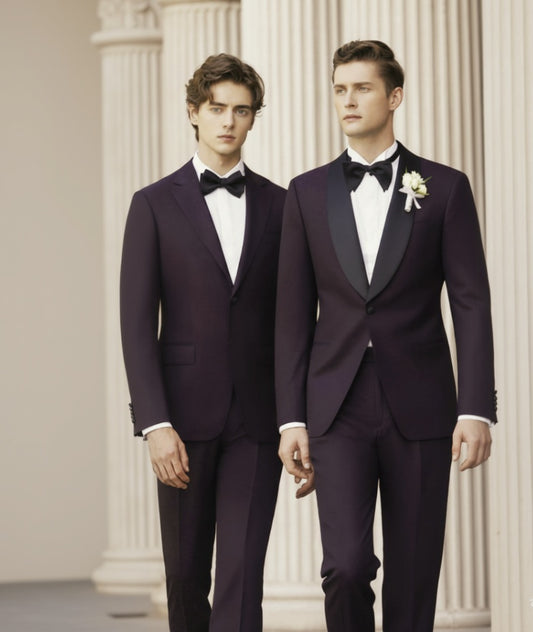 Two men wearing purple jacquard evening suits with matching trousers, one with a jacket and waistcoat and the other with a bow tie and a flower pin.