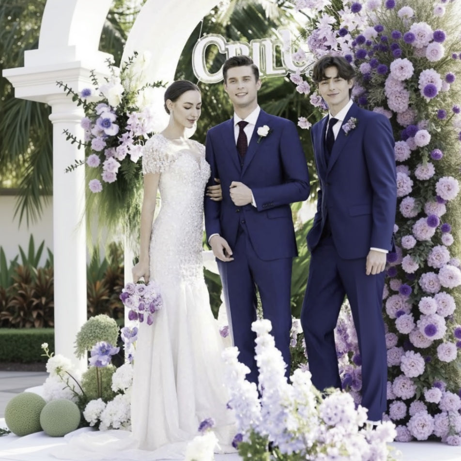 Wedding couple standing in front of a floral arch with 'Chloe' written on it.