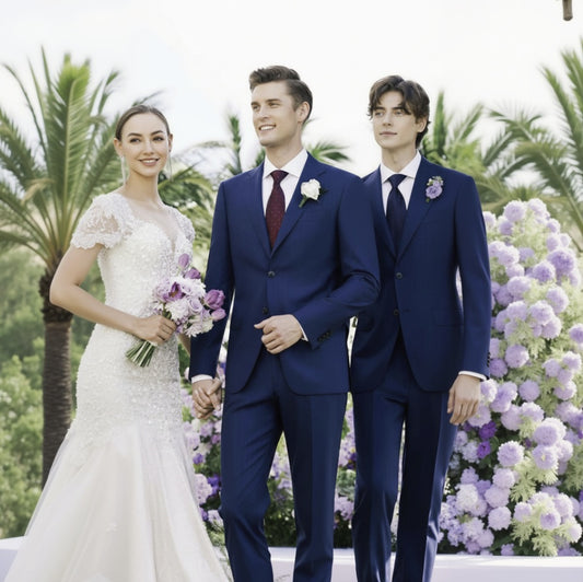 Wedding couple with two men in blue suits standing in front of floral decorations.