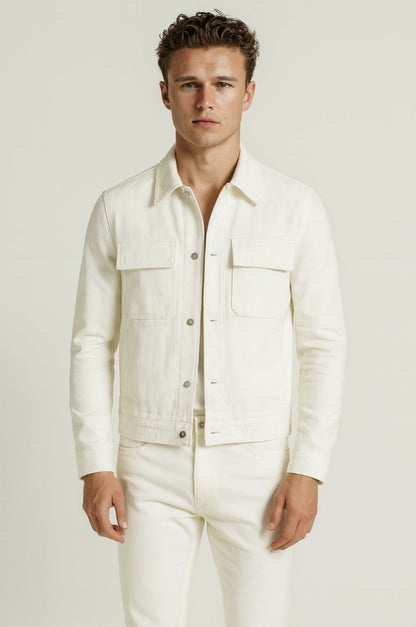 Man wearing a white linen shirt and pants against a plain background