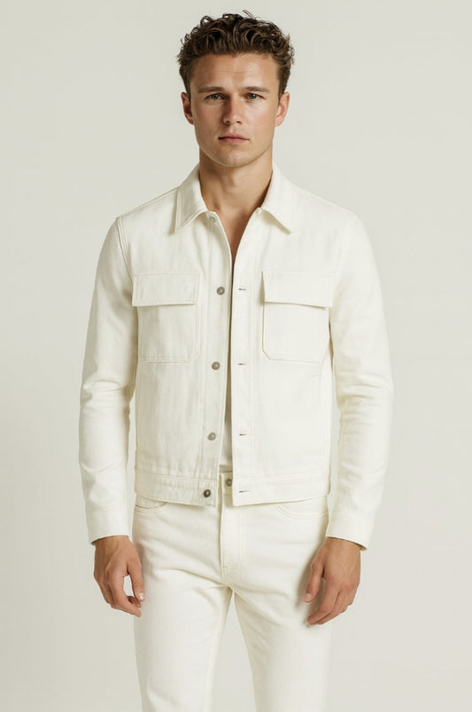 Man wearing a white linen shirt and pants against a plain background