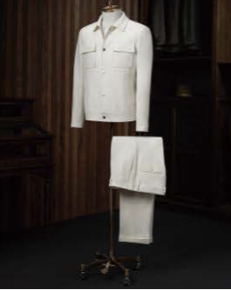 A white wool casual jacket and white wool trousers displayed on a mannequin against a wooden background.