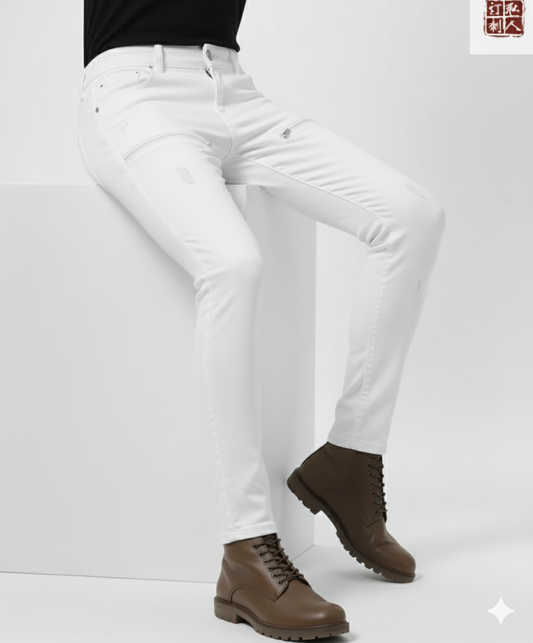 Person wearing white jeans and brown boots on a plain background