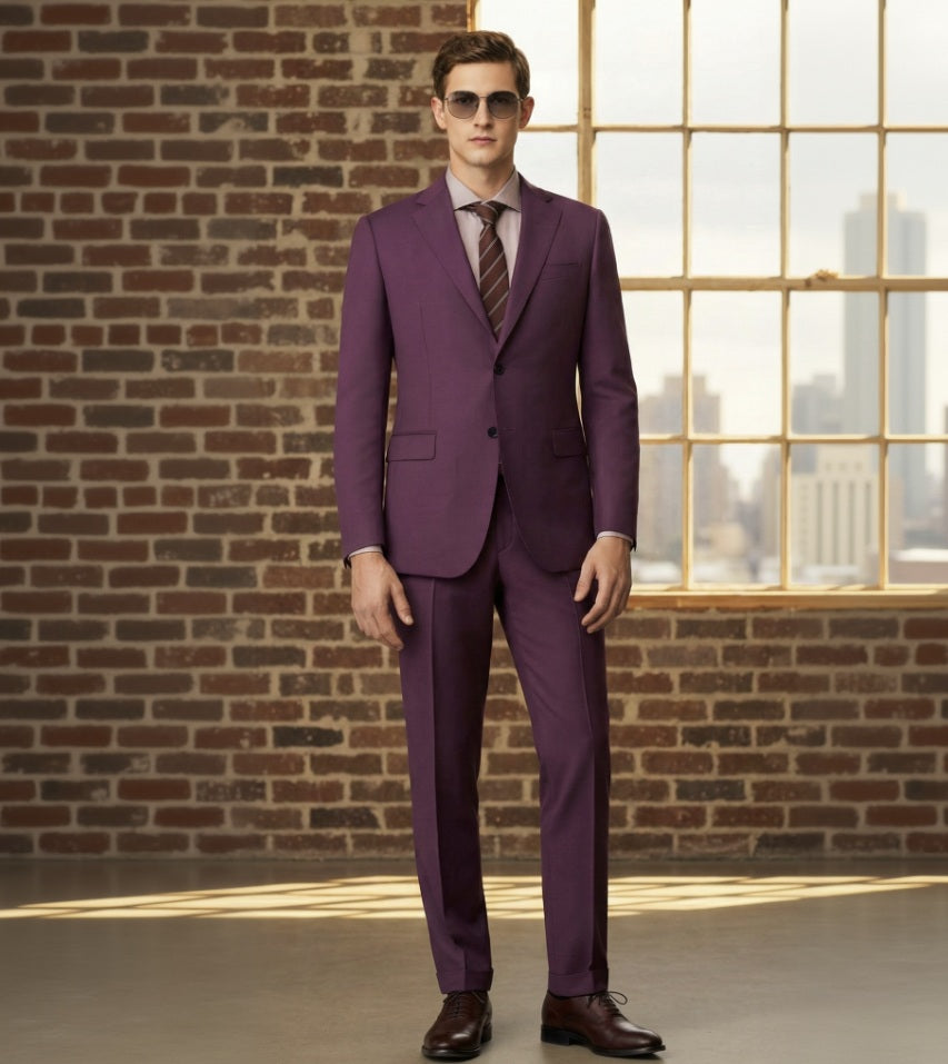 an wearing a Red suit with sunglasses in front of a brick wall and window.