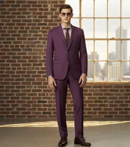 an wearing a Red suit with sunglasses in front of a brick wall and window.