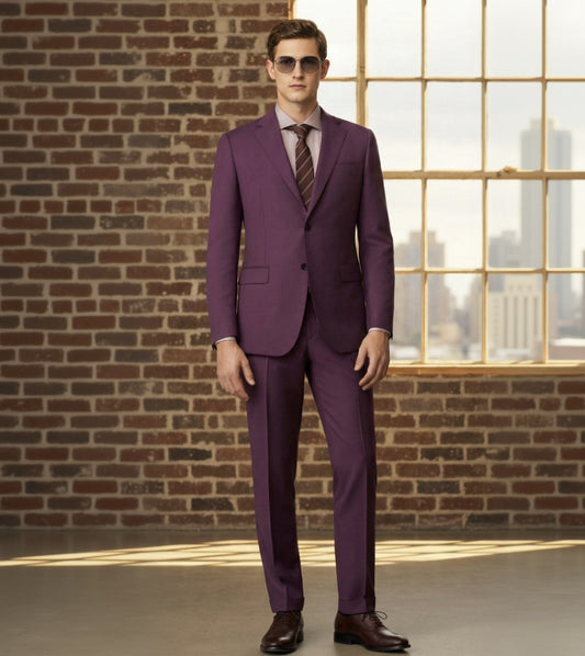 an wearing a Red suit with sunglasses in front of a brick wall and window.